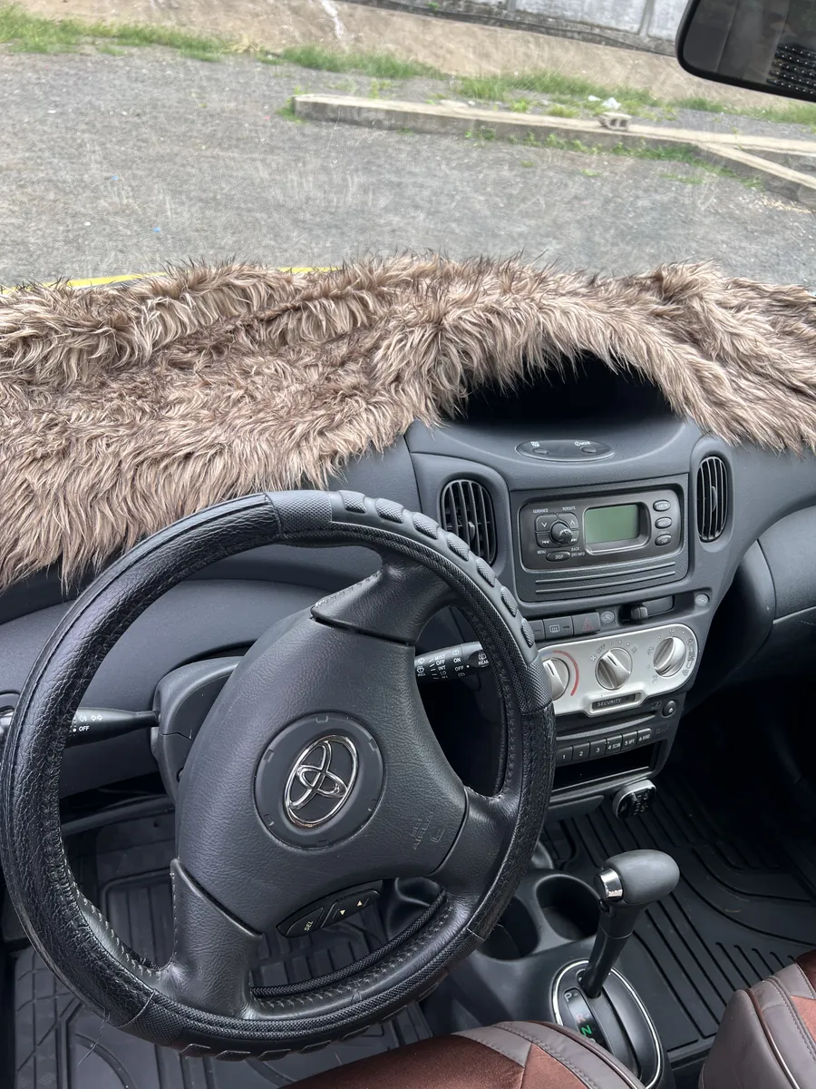 Toyota Yaris Verso interior steering wheel and dashboard with AC controls